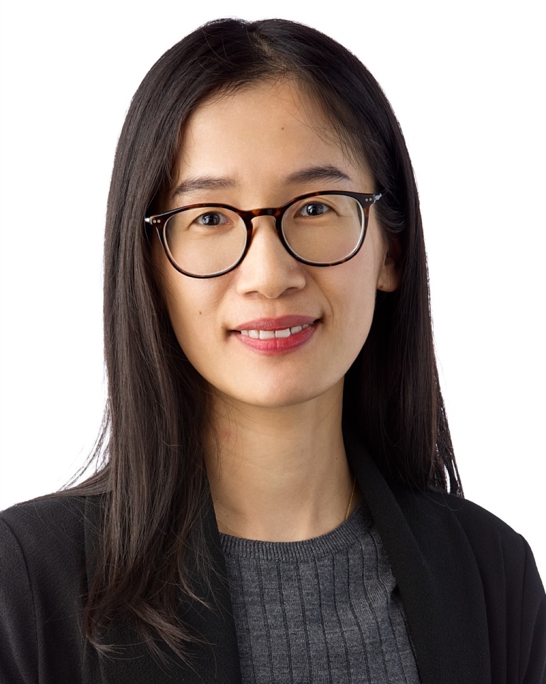 Corporate headshot of a woman in a blazer on white