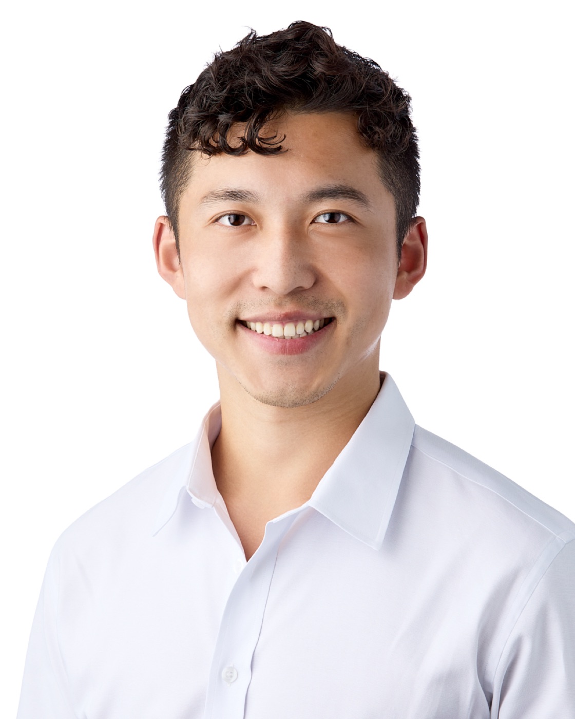 Business-casual headshot of a man in a white shirt on white
