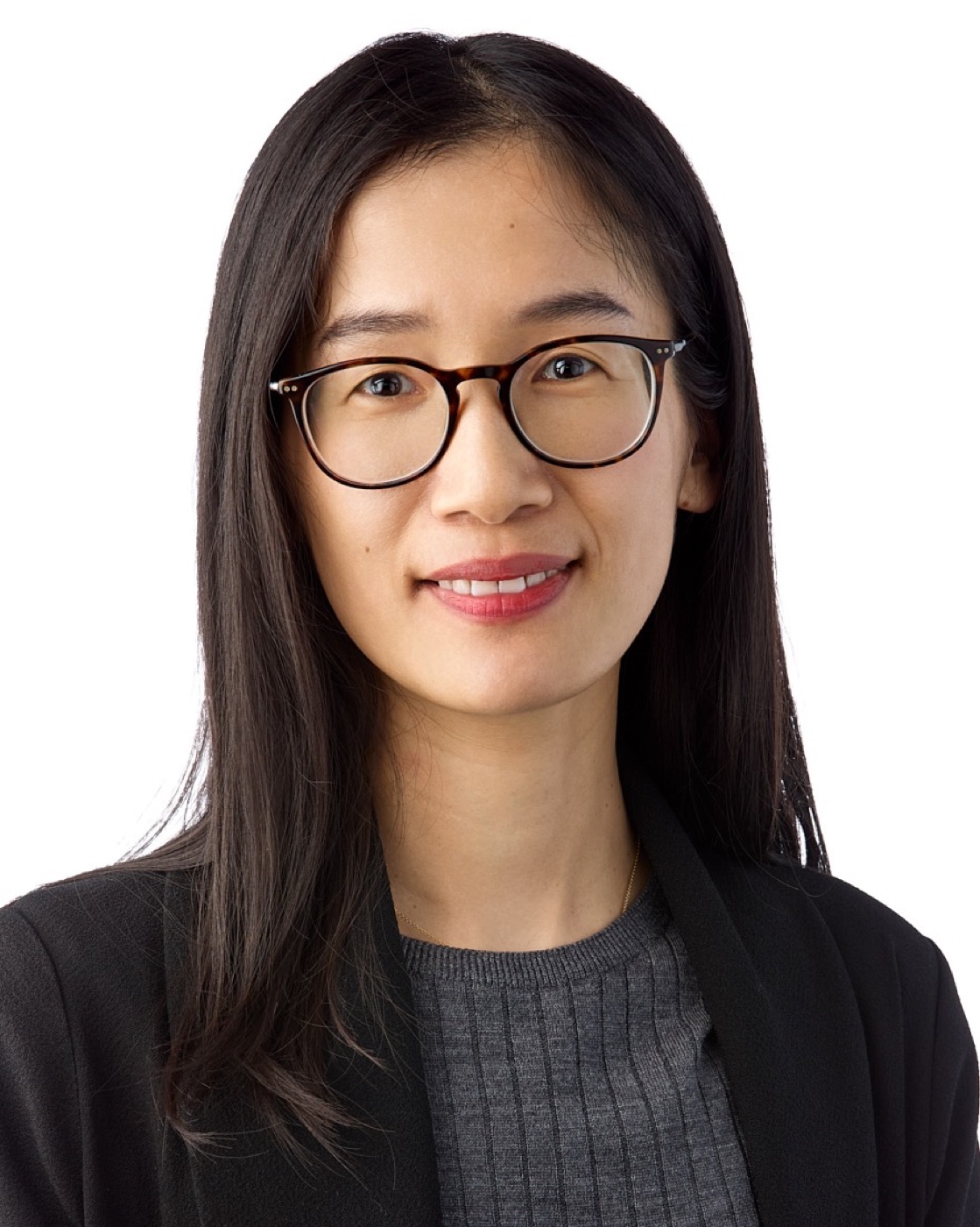 Corporate headshot of a woman in a blazer on white