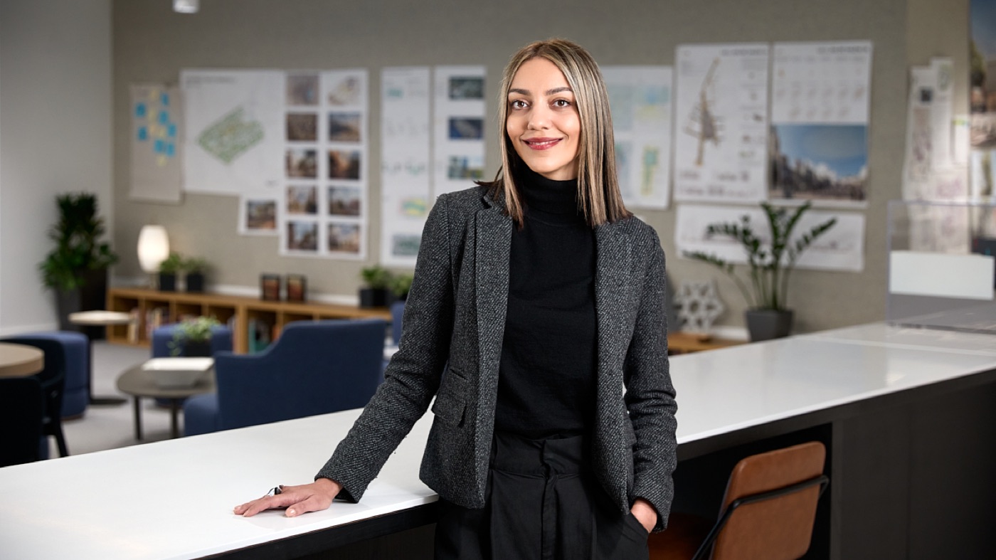 Environmental portrait of a woman in a tweed blazer in a design studio